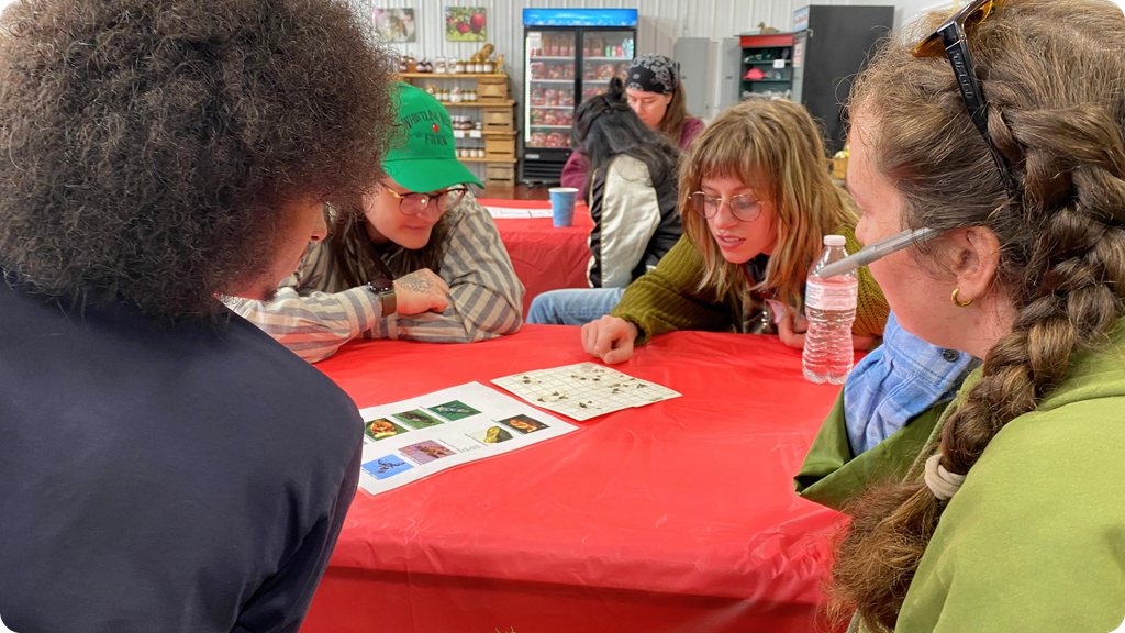 Rivers Co-op Markets produce team members look at pest traps that Whistling Well uses in their Integrated Pest Management.